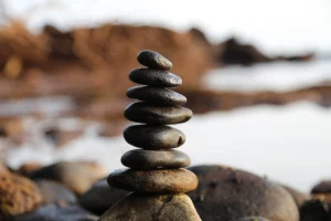 Achieving work-life balance is made simple with this serene image of stones balanced on a beach, reminding us to take a break and relax. A great visual to keep in mind while planning your week with a weekly planner.