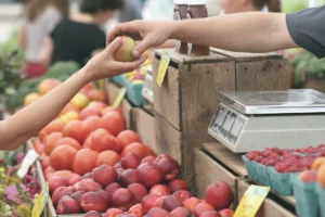 Fetch Rewards explained: A person scanning their grocery receipt to earn rewards while buying fresh fruit. Use your earned points to save on your next grocery trip and enjoy more healthy meals like this one.