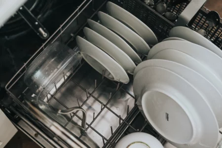 This is an image of a dishwasher efficiently washing dishes, a smart way to save money on your electric bill. 