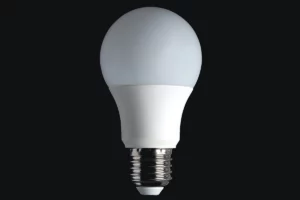 An LED lightbulb on a black background - an energy-efficient lighting option as part of tips on 'How to Save Money on My Electric Bill'.