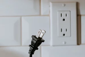 An unplugged electric cord - a reminder to unplug electronics when not in use as part of tips on 'How to Save Money on My Electric Bill'.