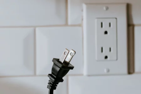 This is an image of an unplugged appliance from an outlet, representing ways to save money on your electric bill by reducing energy consumption.