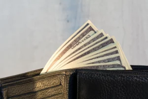 This is an image of a wallet and money, representing ways to save money on your electric bill